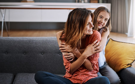Care, hug and mother with daughter on sofa for bonding, connection and love. Happy, support and...