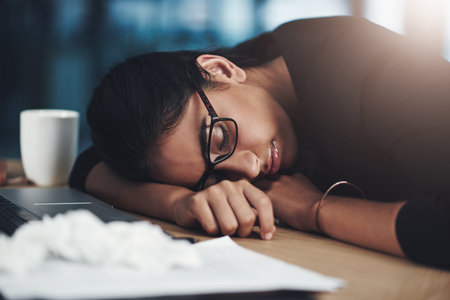 Business, woman and tired with sleeping in office for low energy, flu fatigue and workload pressure....