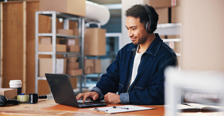 Headphones, laptop and logistics with man in office for delivery schedule or storage management....