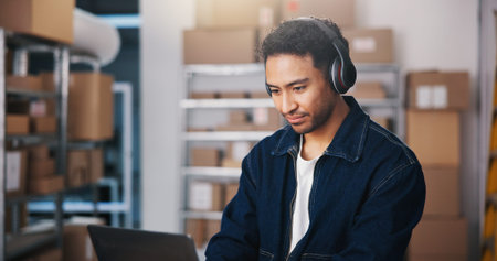 Headphones, ecommerce or man with laptop in small business, check order status or streaming music....