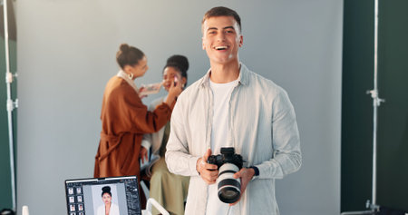 Photographer, portrait and man with camera, studio and creative team in backstage or post...