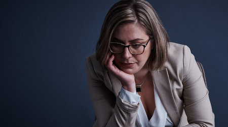 Business woman, doubt or studio with depression for stress or debt on a dark background. Frustrated,...