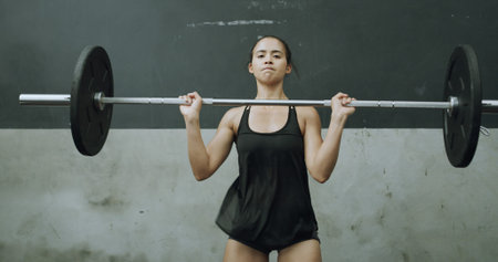 Portrait, woman and strong with barbell, gym and workout routine for muscle development or wellness....