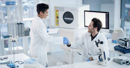 People, team and shaking hands for science at lab with clipboard, smile or medical research for...