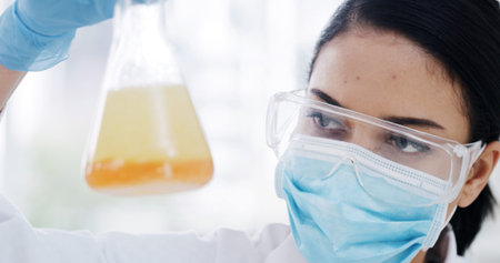 Woman, beaker and scientist at lab with liquid, sample or reaction medical research for virus cure....