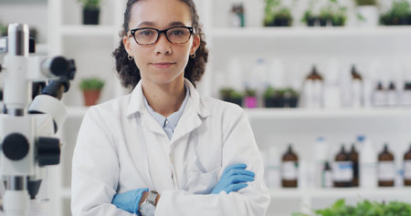 Woman, crossed arms and portrait of scientist in laboratory with confidence for science career. Research, glasses and female chemist with pride for pharmaceutical innovation with medical development.の写真素材