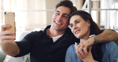 Happy couple, selfie and relax on sofa in home with bonding, connection or care with web post. Man,...