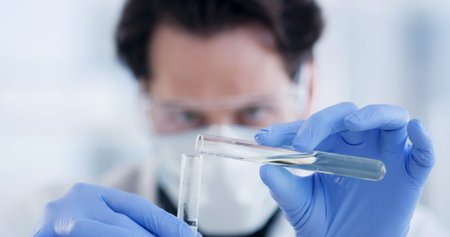 Scientist, hands and man with mix for solution, medical research and chemistry in laboratory. Sample...