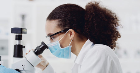 Woman, scientist or microscope with face mask for exam, medical test or forensic study in...