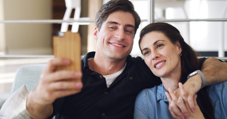 Happy couple, selfie and hug on sofa in home with bonding, connection or care with web post. Man,...