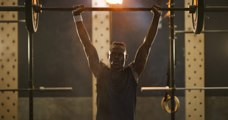 Fitness, black man and barbell for bodybuilding in gym, exercise and strength training for wellness....