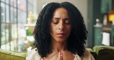 Yoga, woman and meditation in home for relax, zen and inner peace with mindfulness. Yogi, breathing exercise and person in living room for holistic health, spiritual wellness or calm with healingの写真素材