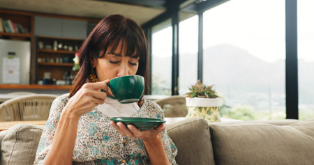 Relax, morning and woman with coffee on sofa for calm, wellness and warm beverage in home. House,...