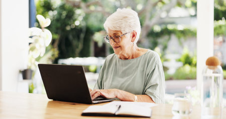 Reading, laptop and senior woman in home, planning for retirement fund and investment portfolio....