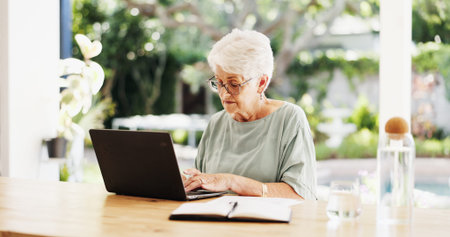 Reading, laptop and senior woman in lounge, planning for retirement policy and investment portfolio....