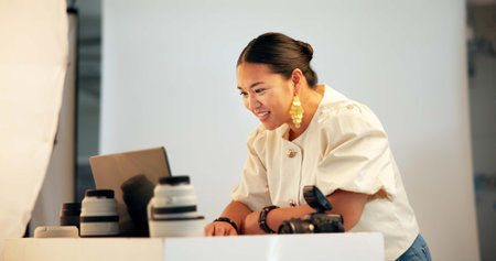Photographer, woman and happy with laptop in studio for photoshoot results, color grading or...
