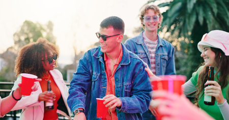 Outdoor, party and friends with drinks on balcony, speaking and social gathering for weekend...