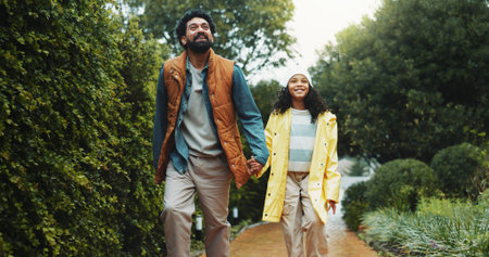 Holding hands, outdoor or father with daughter on path for holiday, connection or care for nature...