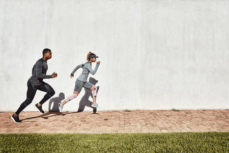 Fitness, team or running exercise outdoor for race practice, speed training or personal trainer pace. Fast, runner and coach with sprint at park for athletic performance, challenge and mockup spaceの写真素材