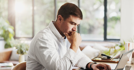 Remote work, thinking and man on laptop in home for research, budget review and finance report....