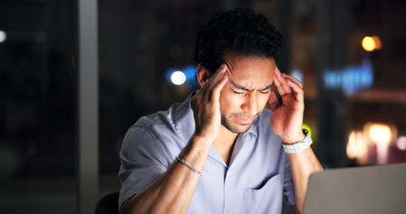 Night, creative agency and man with headache, laptop for article rejection and blue light exposure....