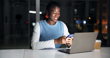 Night, laptop and black woman in office with phone, journalist research and text message for story....