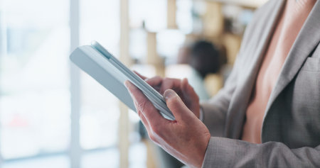 Hands, review and tablet with typing for report, proposal and notes in office at insurance company. Person, broker or tech with click, checklist and app in boardroom at risk management agencyの写真素材