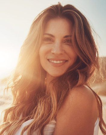 Portrait, beach and woman with smile for travel, vacation or tourism with sunset. Holiday, fresh air and female person on tropical island trip with hairstyle in nature and outdoor for weekendの写真素材