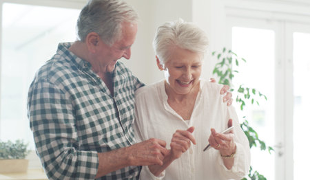 Phone, senior and couple in home with happiness, reading good news or notification. Mobile, elderly man and woman in house for internet, connection or share message for pension increase in retirementの写真素材