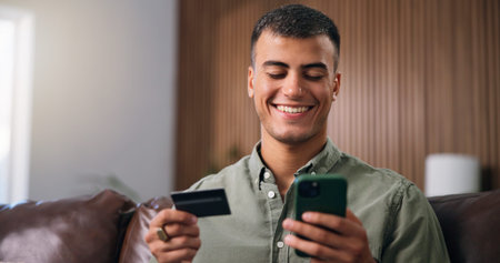 Credit card, smartphone and man on sofa in home with online shopping, ecommerce or purchase on...