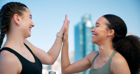 Runner, happy and women high five in city for exercise, workout and training together. Sports, smile...