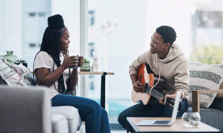 Happy couple, guitar and playing with coffee in home for entertainment, bonding or music together....
