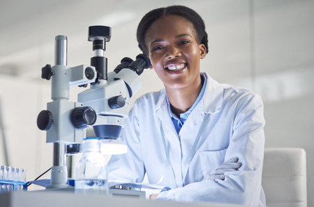 Portrait, scientist and black woman in laboratory with microscope, research and development....