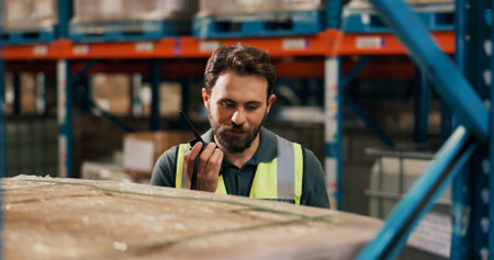 Businessman, contractor or talking with radio in warehouse for logistics or supply chain safety....