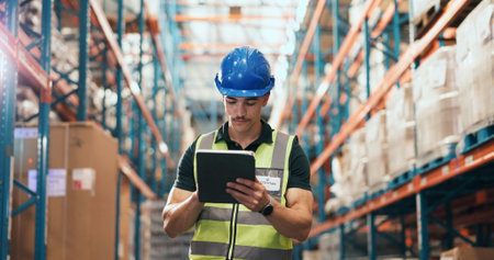 Man, tablet and typing at warehouse for logistics with notes, schedule or inventory management at...