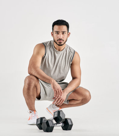 Fitness, man and portrait with dumbbells in studio for weightlifting, muscle exercise and workout....