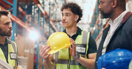 Logistics, meeting and man in warehouse with helmet for safety, discussion and PPE. Protection,...