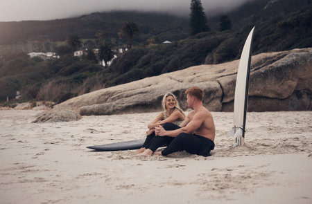 Couple, relax and board by ocean with surfing break, bonding together or summer holiday activity....