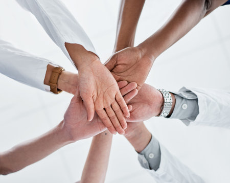 Doctor, huddle and hands together with meeting for unity, collaboration or mission at hospital. Low...
