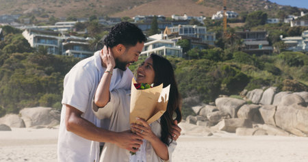 Smile, couple and hug with bouquet at beach for romantic date, celebration and bonding together....