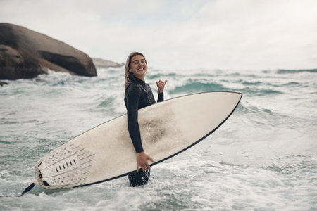 Surfer, woman and smile with beach, portrait and shaka sign for ocean hobby or vacation fitness....
