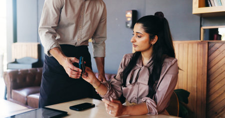 Woman, credit card and waiter with pos at cafe for easy payment, bills and customer experience at...
