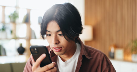 Smartphone, reading and Asian man in home for blog on social media, update profile and connection....