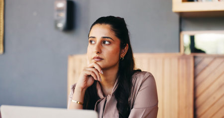 Thinking, creative and woman in coffee shop on laptop for editing, online article or submission...