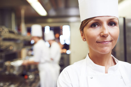 Portrait, chef and woman in kitchen for cooking, catering and presentation of food in restaurant....