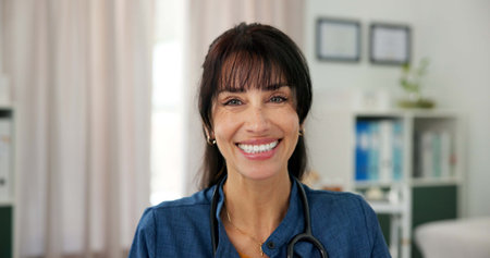 Smile, pride and portrait of doctor in office at hospital with confidence in medical career. Happy, professional and mature woman or healthcare worker with positive attitude in medicare clinicの写真素材