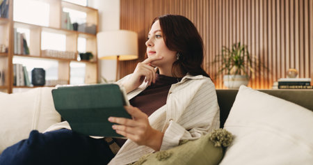 Relax, tablet and thinking with woman on sofa in living room to search review of streaming service....