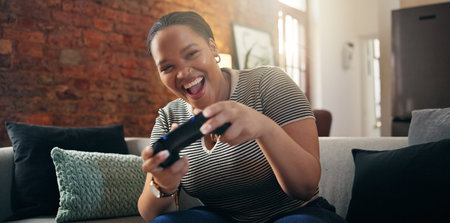 Black woman, gamer and playing with smile on sofa for esport, challenge or tournament in home....