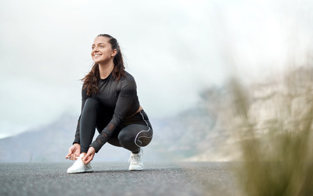 Exercise, woman and tie shoes in road to start workout, cardio preparation or morning wellness....