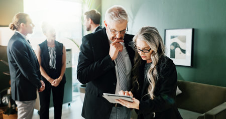 Tablet, business people and team planning in meeting, investment advice or project feedback. Tech, mature manager and review in office for financial report, budget collaboration or problem solving